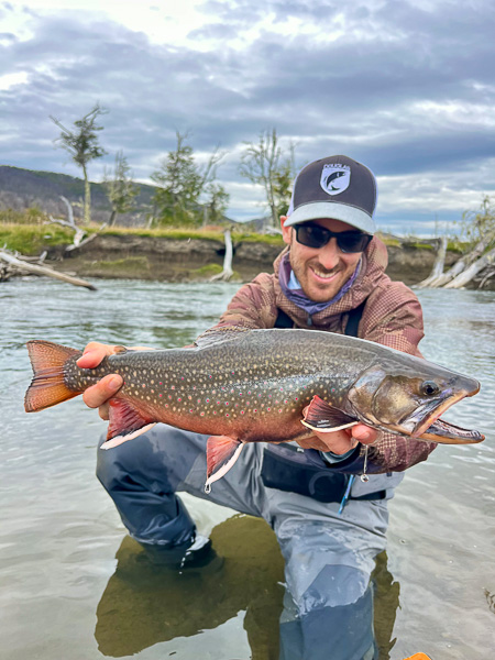 Bug Brook trout caught on dry fly in a quiet river of Tierra del Fuego Patagonia
